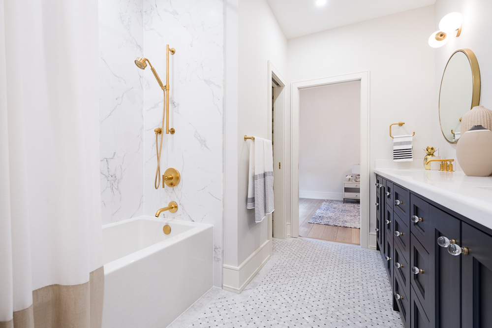 Shared kids' bathroom with brass fixtures