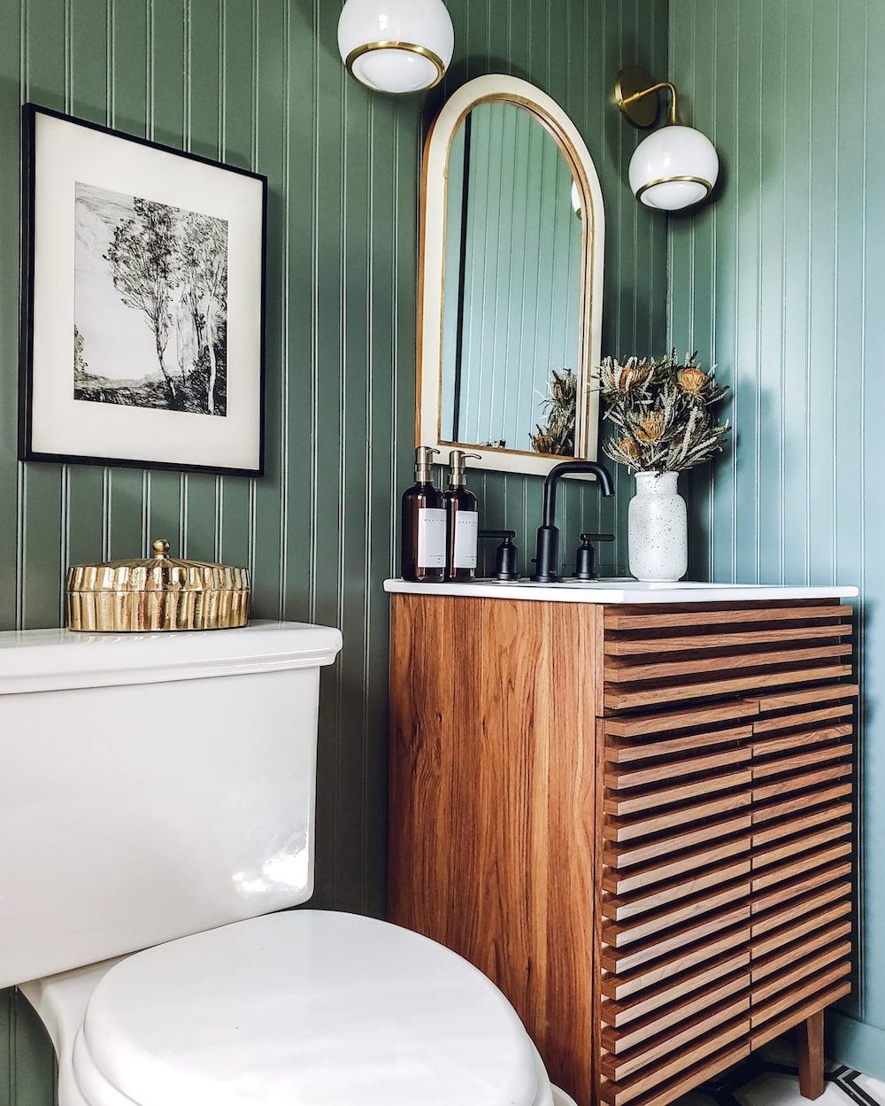 Green wainscotting in bathroom with ridged-wood vanity