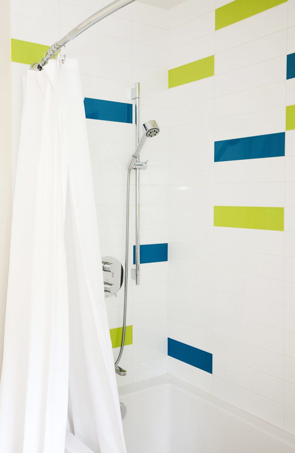 Vivid blocks of tiles in a renovated shower