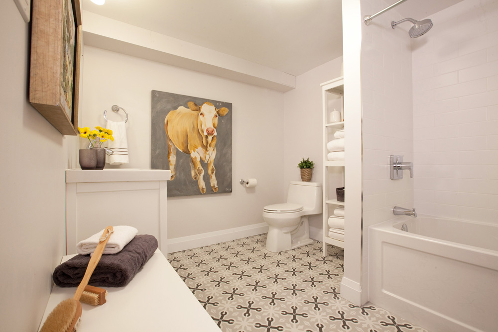A spacious bathroom with farmhouse-style floor tiles
