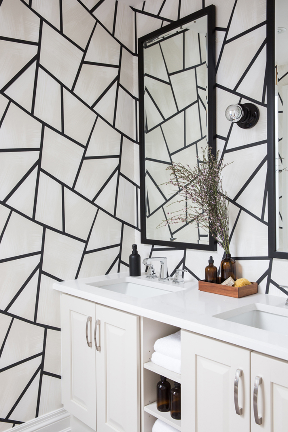 Geometric wallpaper in an otherwise simple, small bathroom