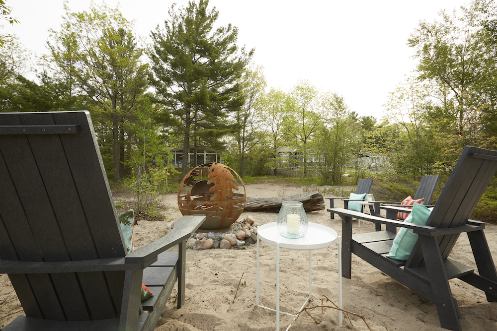 Outdoor firepit with beach chairs on sandy shore