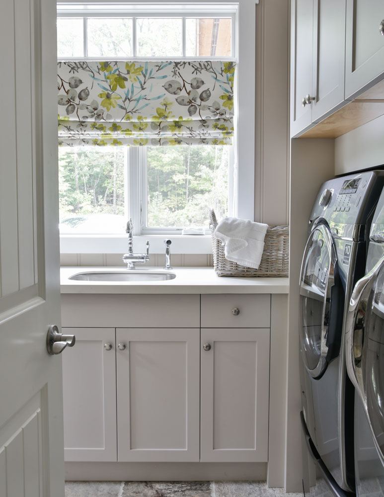 door open to laundry room with floral roman blind