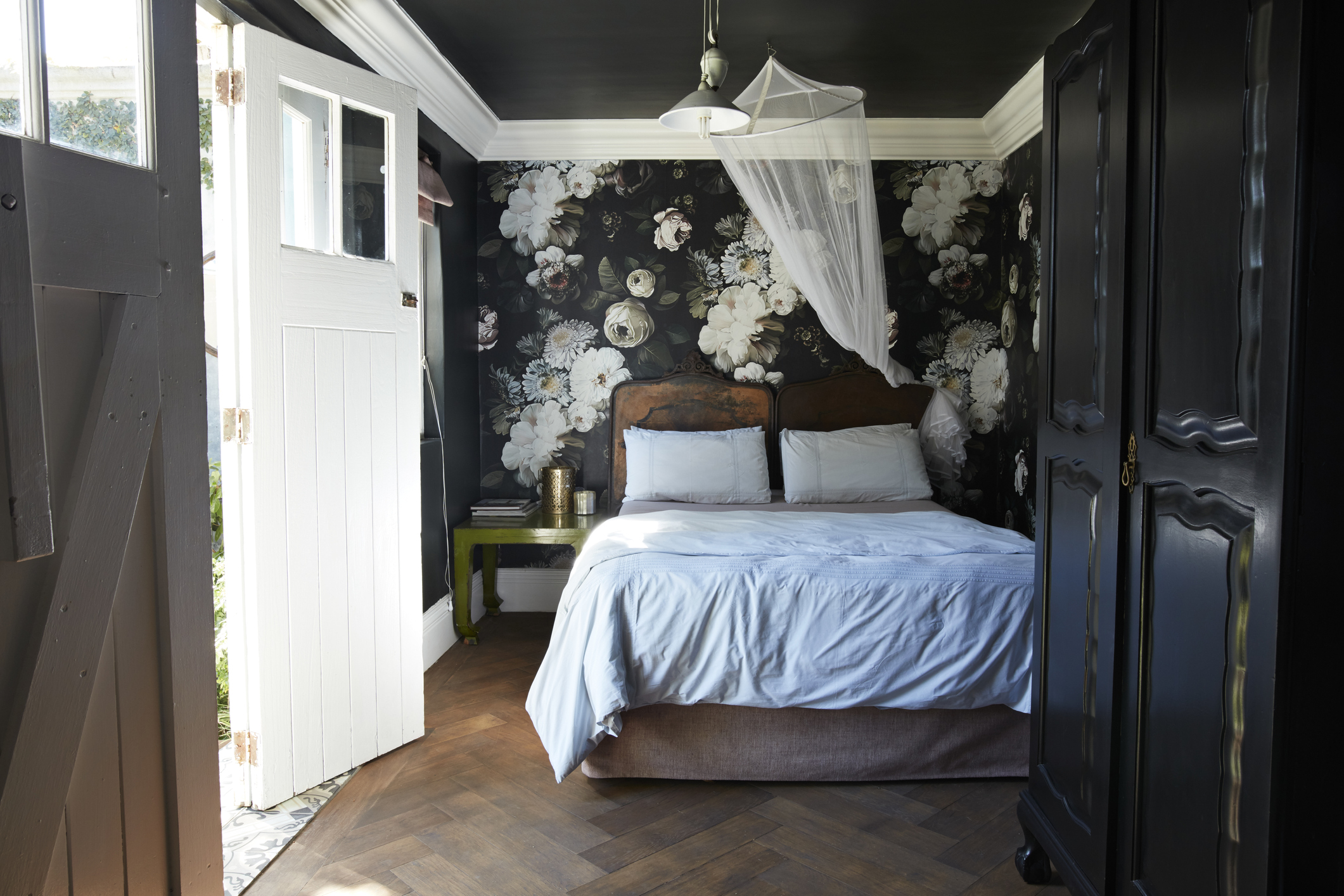 Moody black floral wallpaper in bedroom