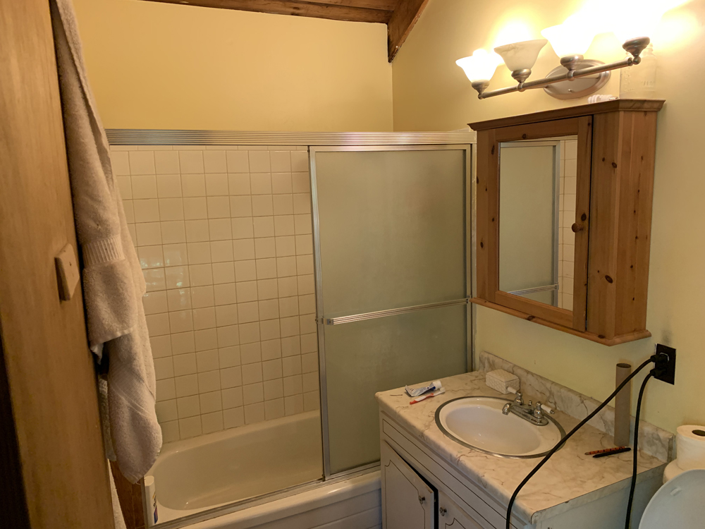 An outdated small beige bathroom