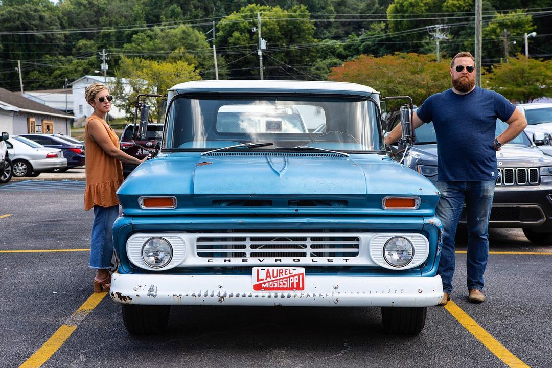 Ben and erin posing next to chevy pickup