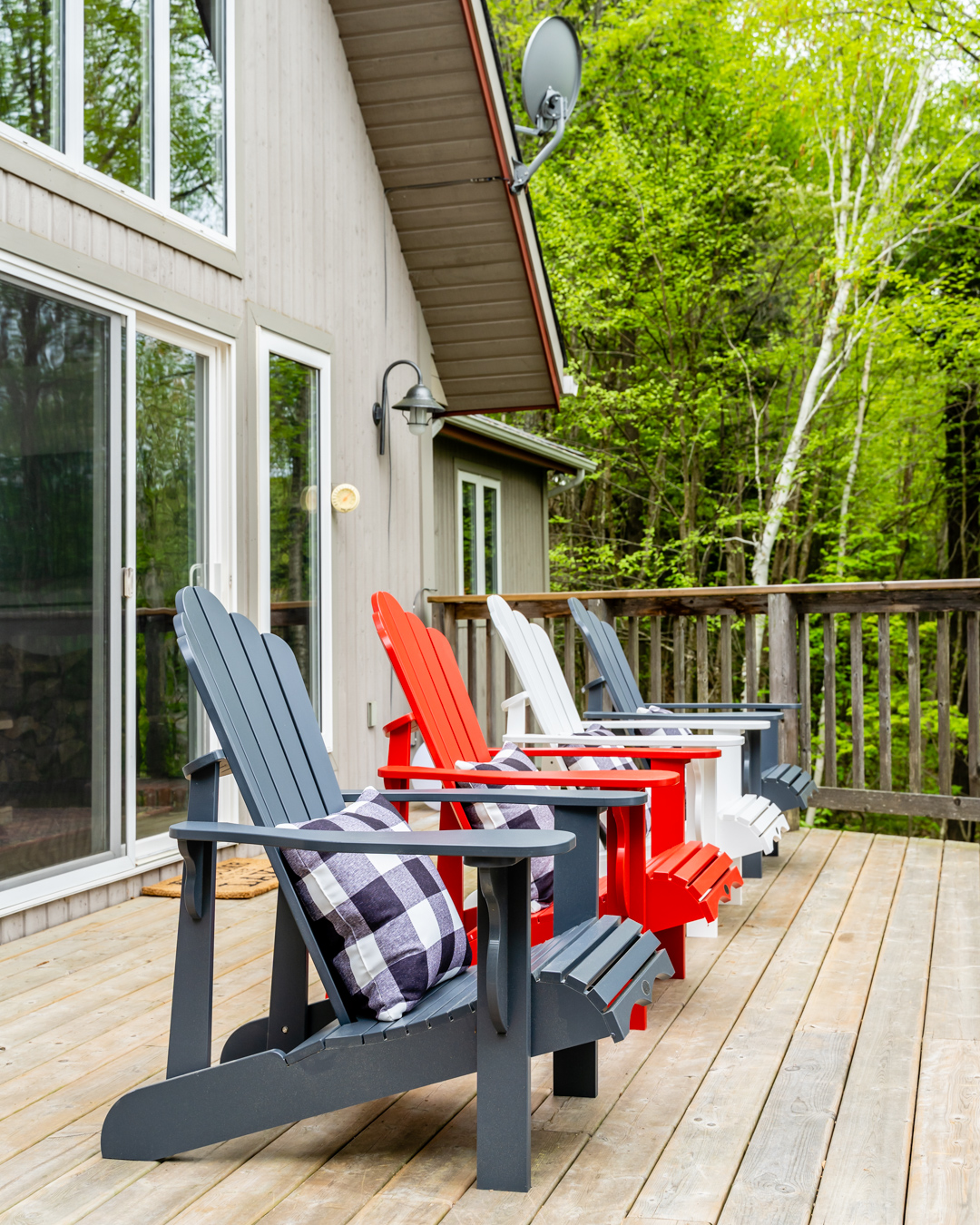 cottage deck four muskoka chairs grey, white and red with blue and white check cushions