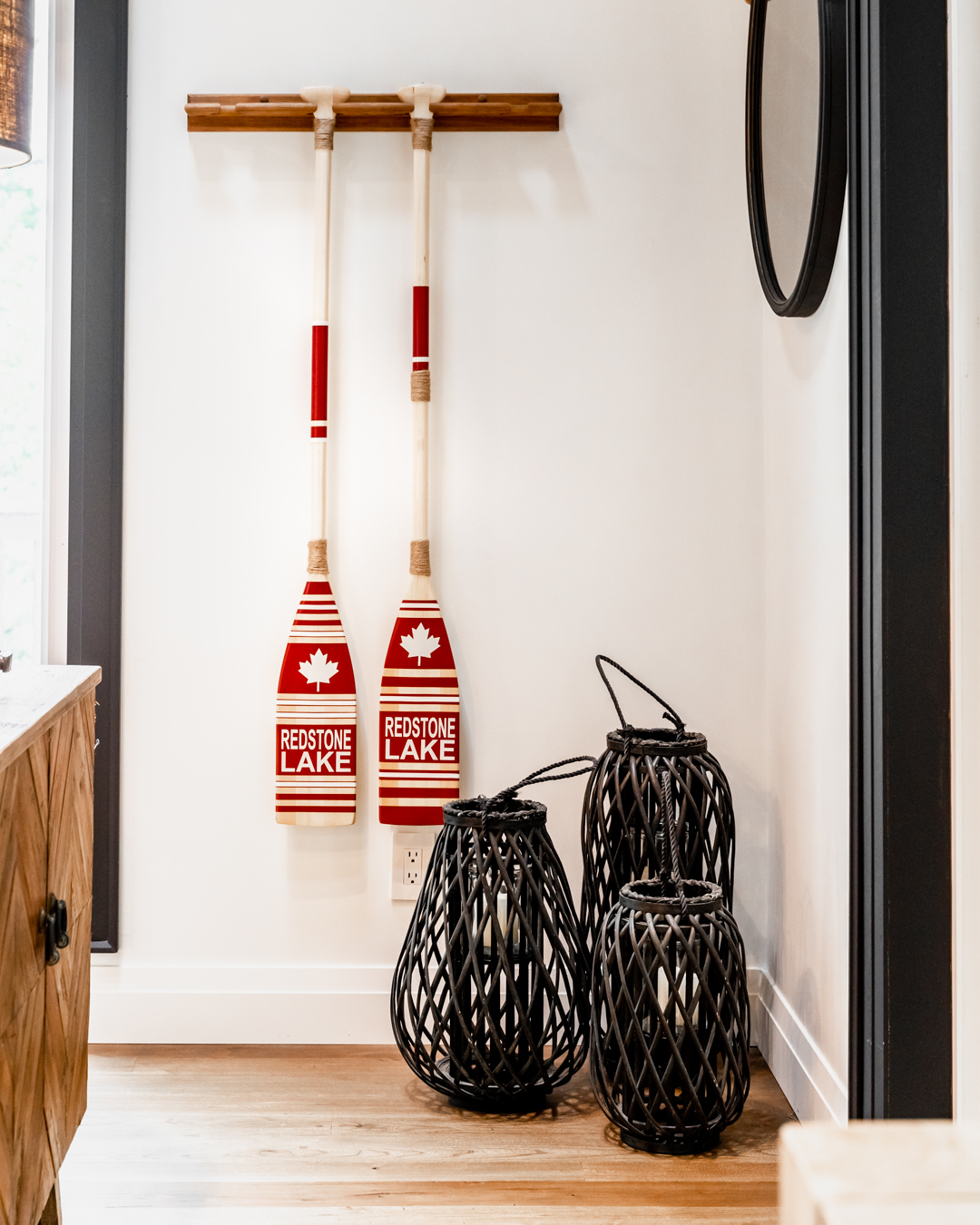 redstone lake red and white oars on wall, three black vessels on floor