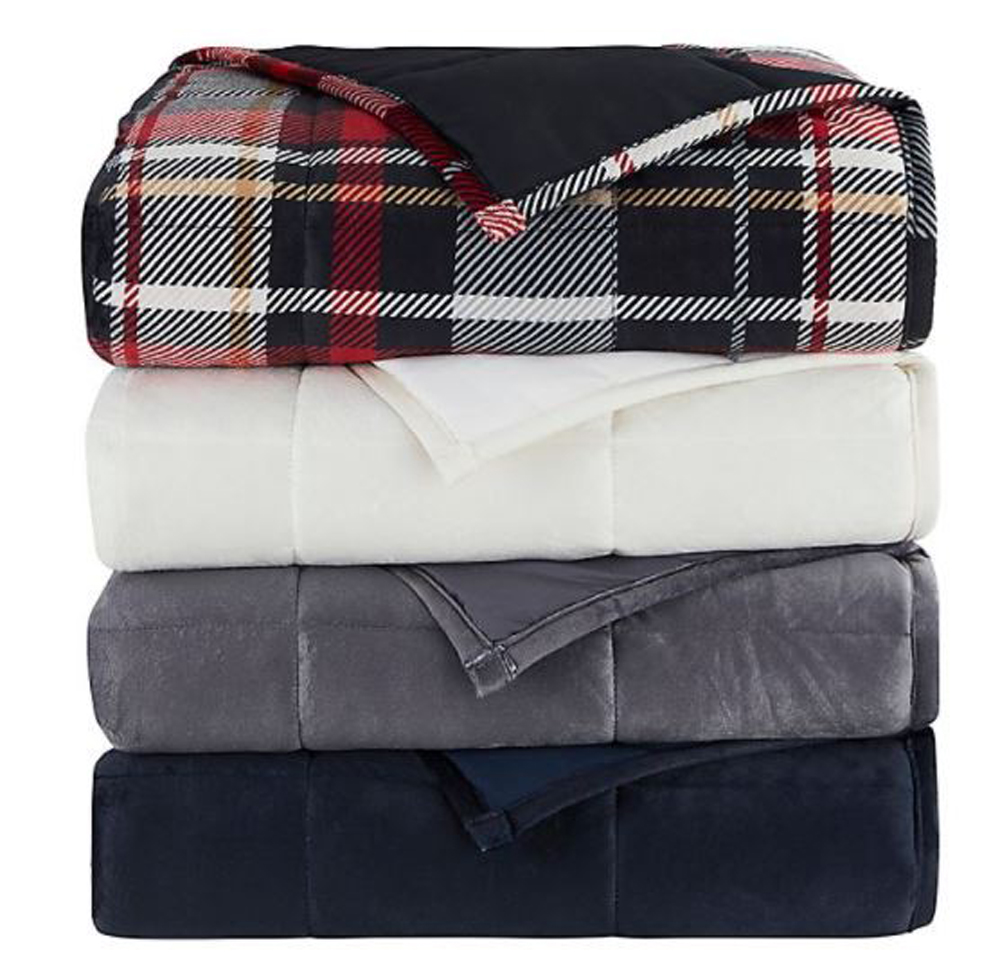 A stack of weighted blankets in various colours