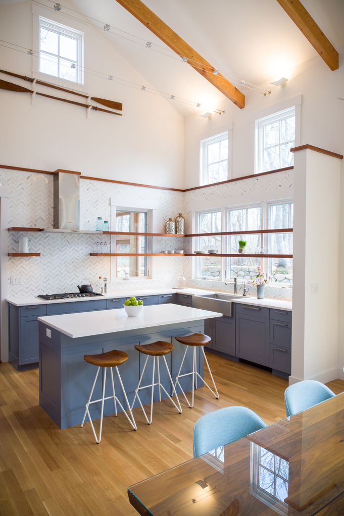 Modern kitchen with pastel blue cabinetry and wood accents.