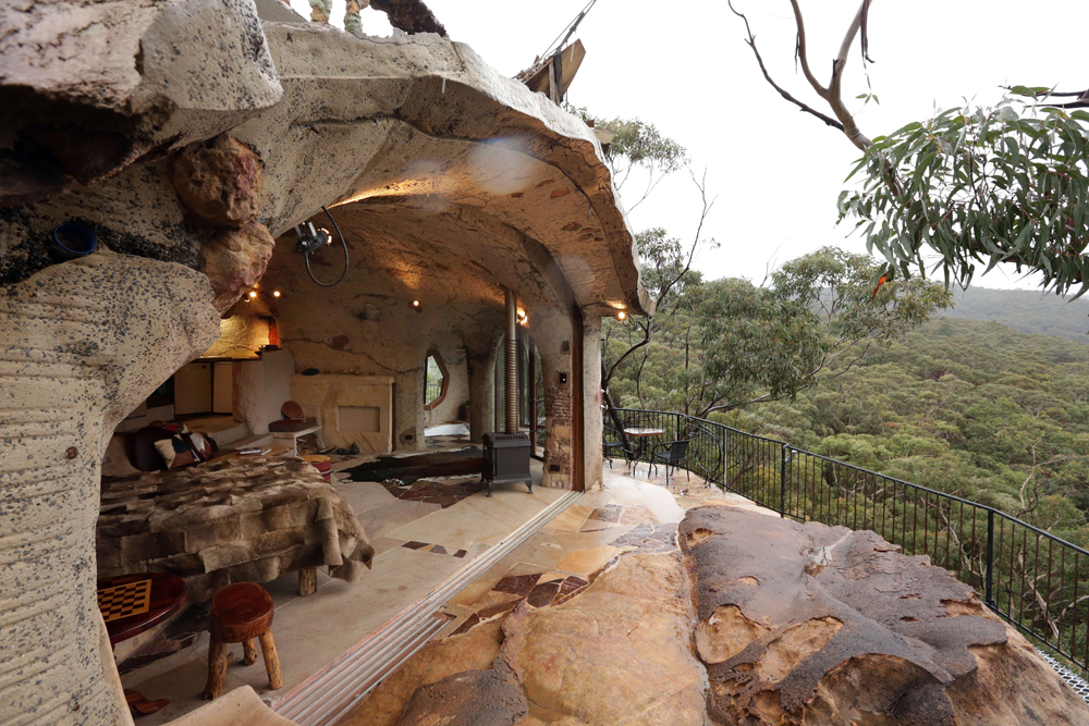 Unique home carved into a cave overlooking a mountain range