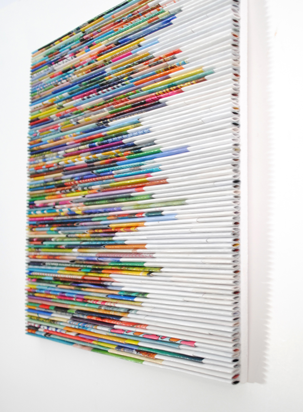 Colourful magazines folded into intricate wall art