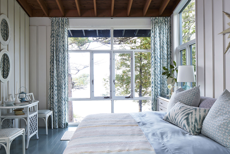 Breezy drapes add a summerhouse feel to this bedroom.