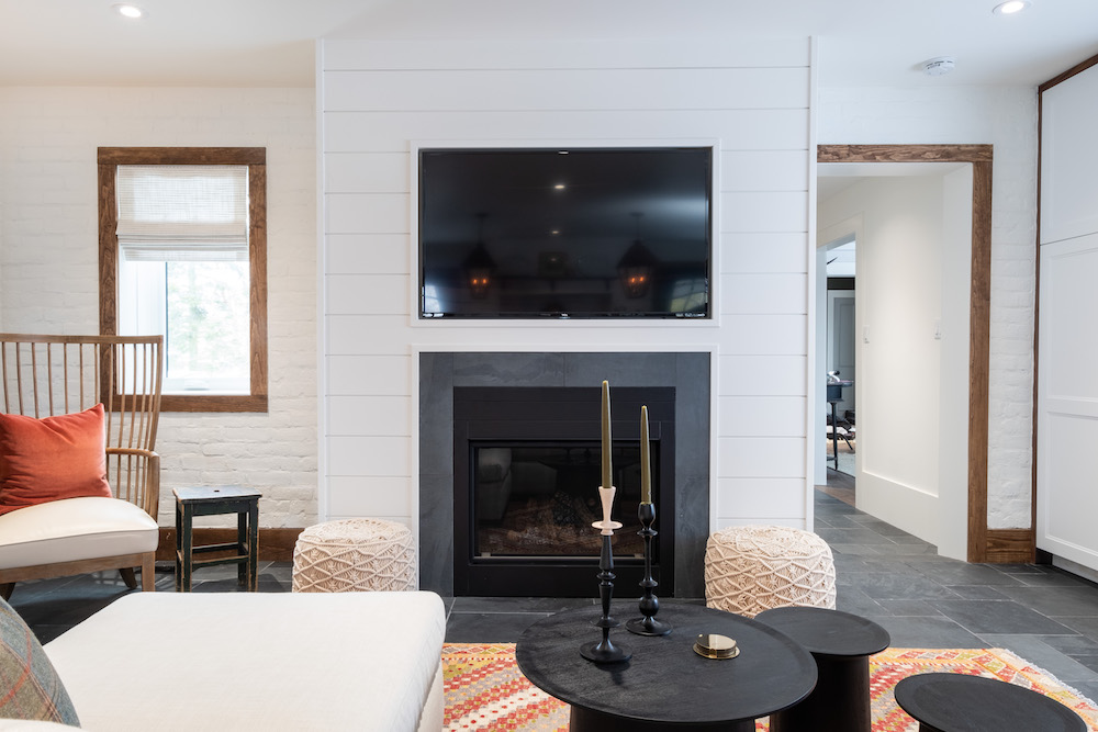 A modern fireplace and TV on shiplap