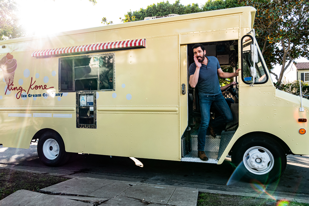 Property Brother Drew Scott calls out from the seat of his beige ice cream truck in Los Angeles