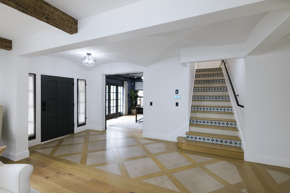 Spanish-influenced patterns on the staircase leading off the front entrance in this renovation