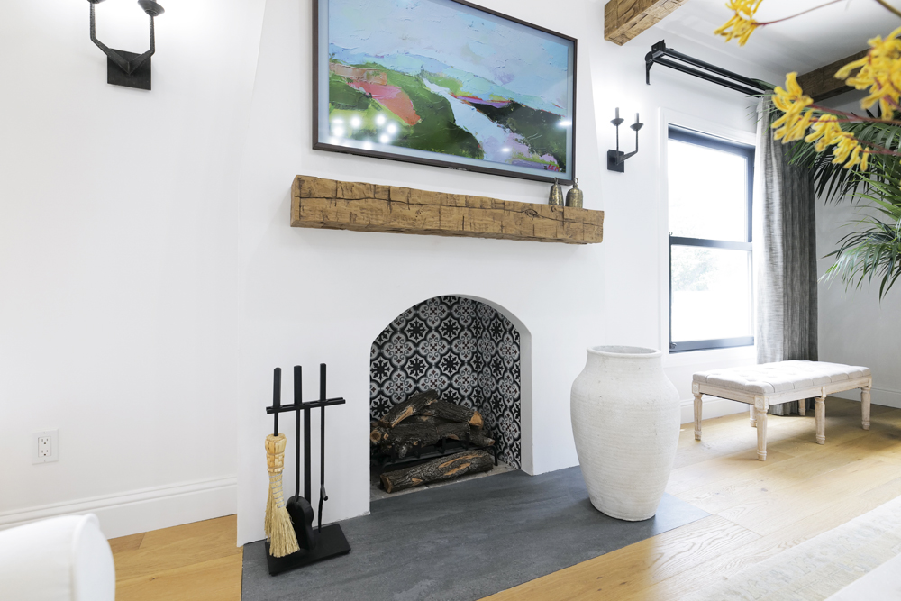 Rustic, organic wood vibe throughout the living room, specifically with the Spanish-inspired fireplace