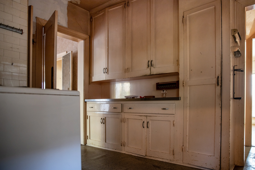 An outdated kitchen with beige cabinetry