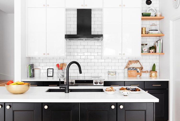 A black and white kitchen with stark black matte hardware