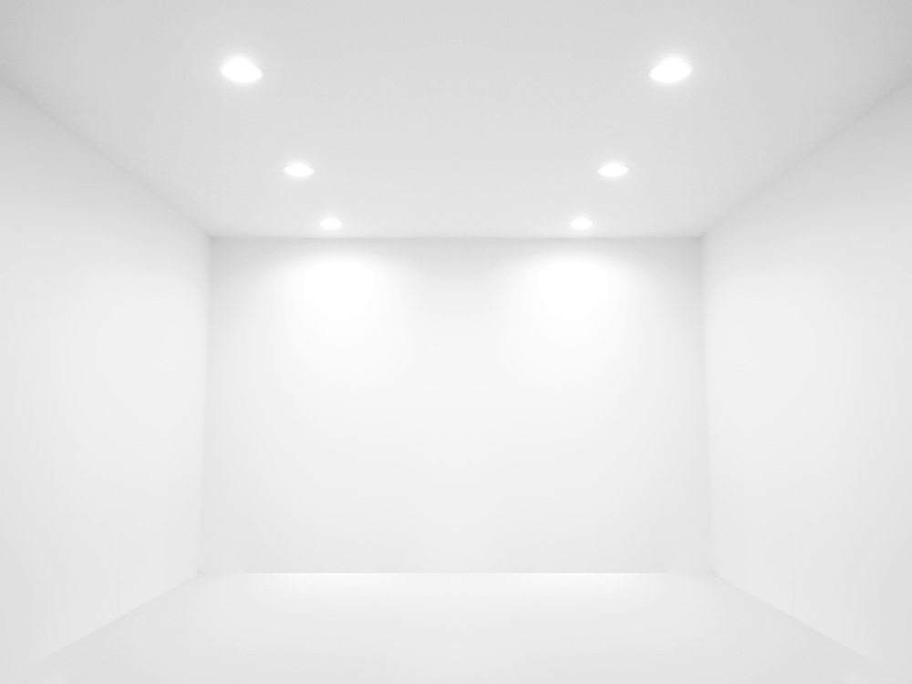 A barren, white room depicting spot lights