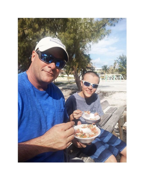 Bryan and Quintyn eating lunch on the beach.