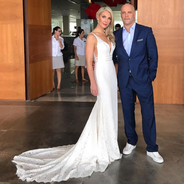 Bryan and Sarah Baeumler dressed up in a wedding gown and tux.
