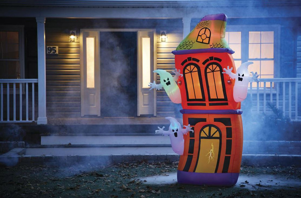 A spooky inflatable haunted house in the front yard of a house