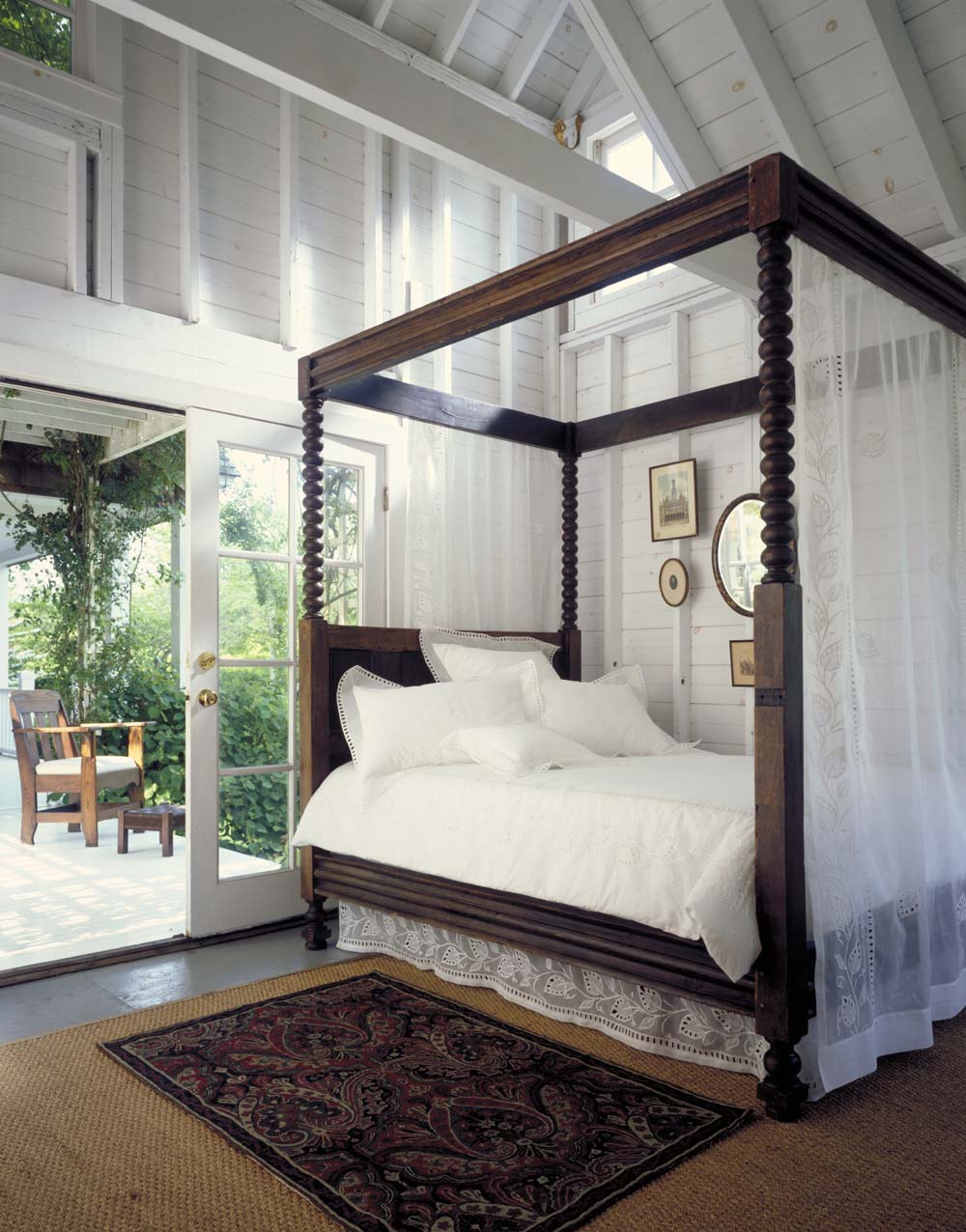 A heavy wood canopy bed with a twisty, spiral design