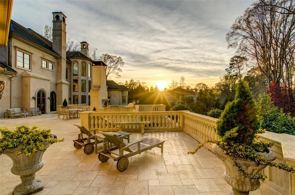 The expansive back deck of the three-storey mansion that overlooks the infinity swimming pool