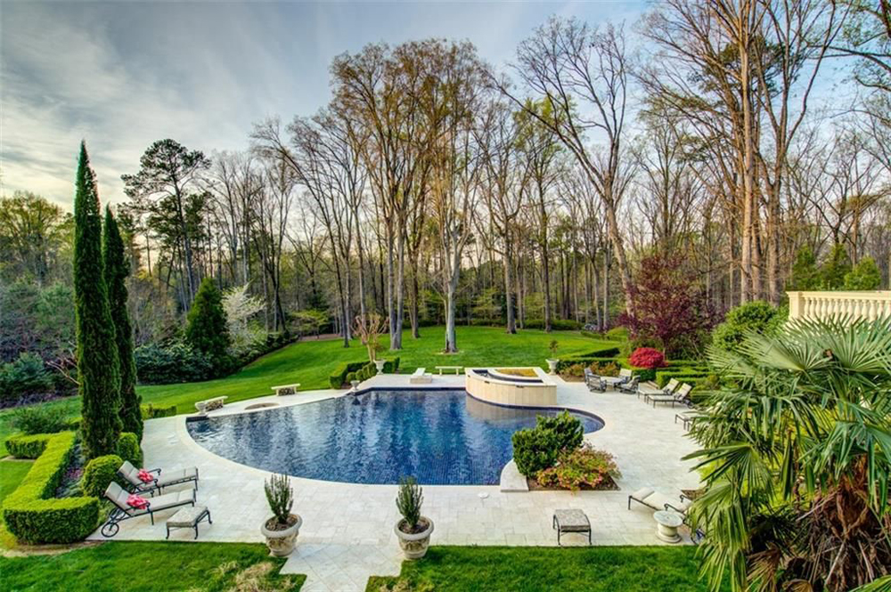 A spacious, heavily forested backyard complete with infinity pool