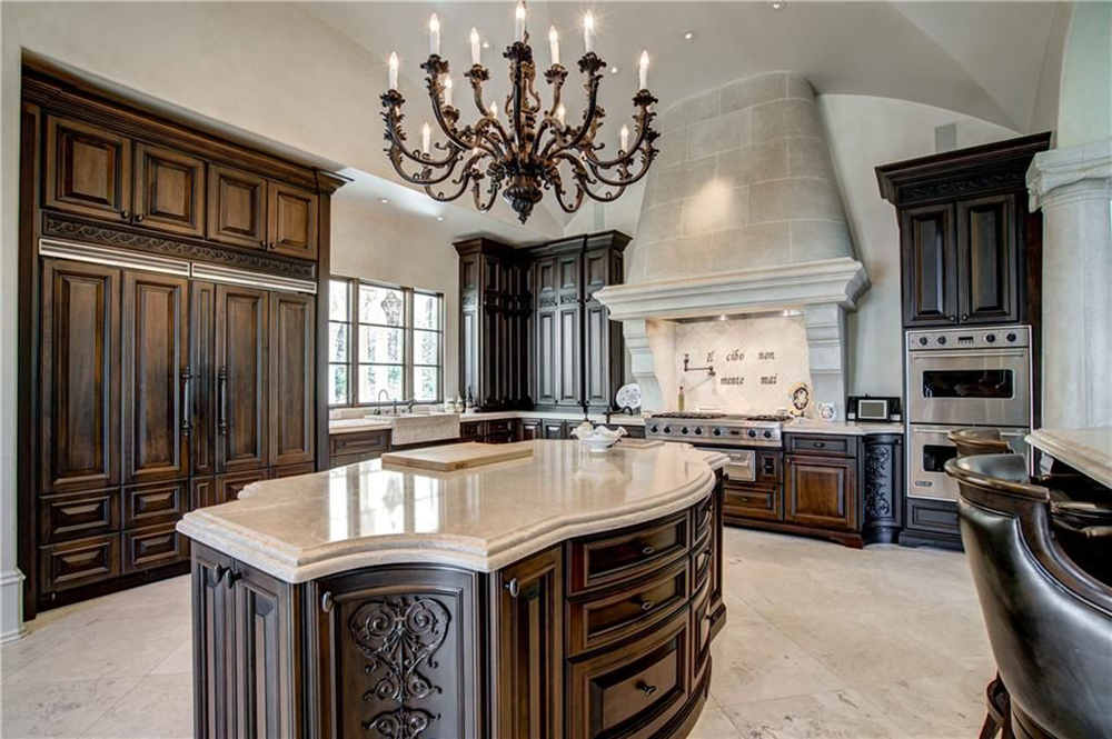 An ornate wood and marble spacious kitchen