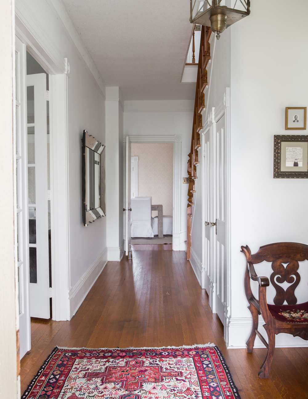 Entryway to a house built in 1903 with hardwood flooring and patterned area rug