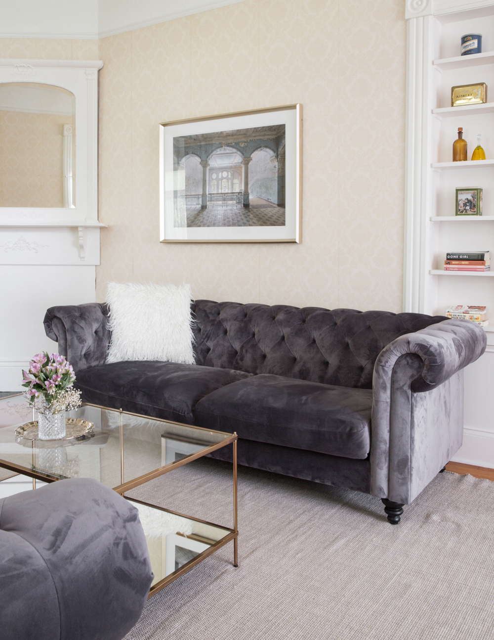 Grey tufted sofas add a modern-vintage flourish to the living room