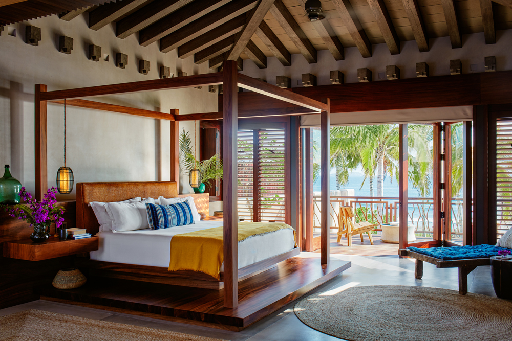 Bright bedroom suite with a private patio overlooking the water
