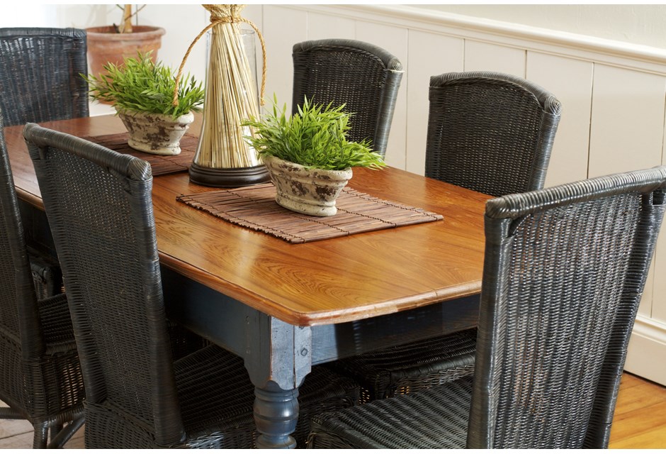 Dark wicker chairs surrounding a polished wood dining room table