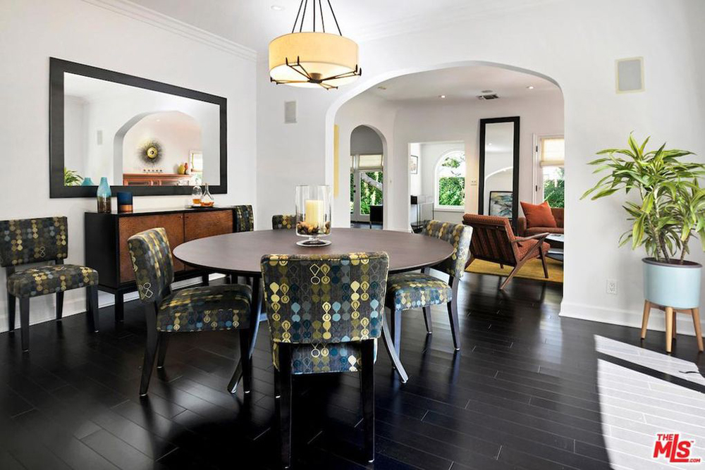 A dining room area with patterned chairs and Spanish-influenced decor