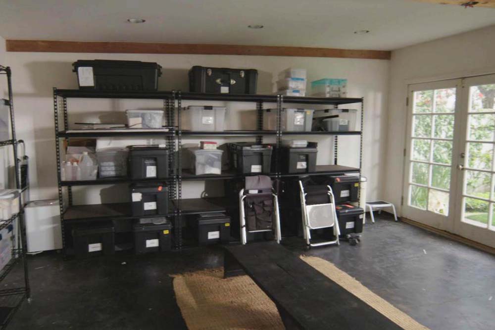 The interior of the gust house is empty save for storage racks and makeup bins