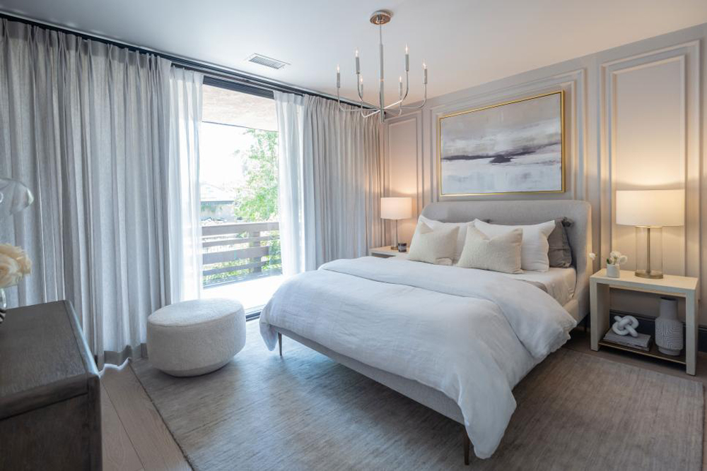 A guest bedroom with a neutral colour palette and white oak floors