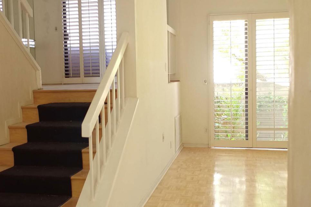 Similar to the living room, the dining room was also outfitted with interior shutters and a mirror wall