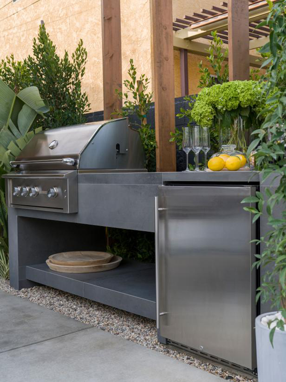 An outdoor modular kitchen with a stunning custom finish and barbecue