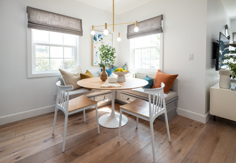 The renovated dining area transformed into a modern breakfast nook with custom-made chandelier