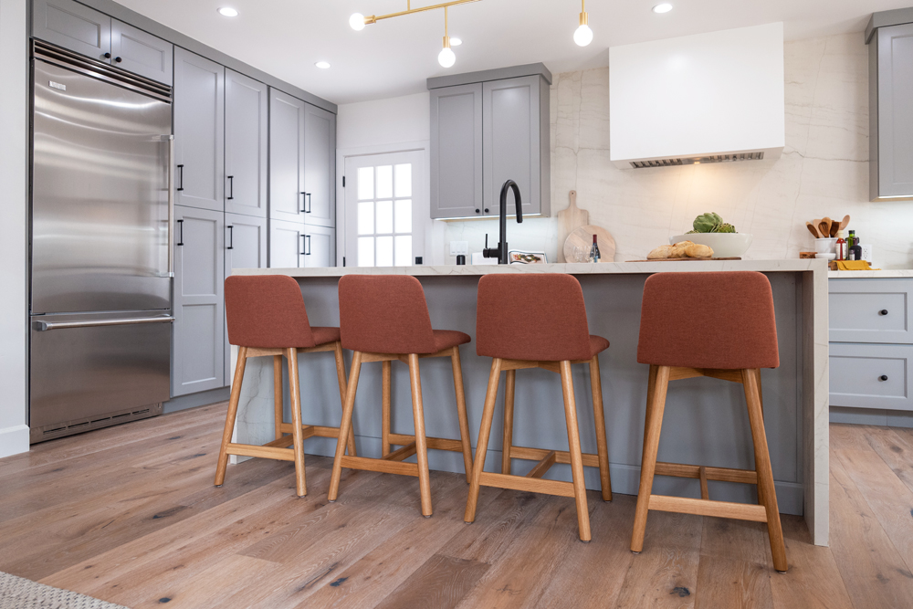 The kitchen island with four chairs pulled up and plenty of new storage space
