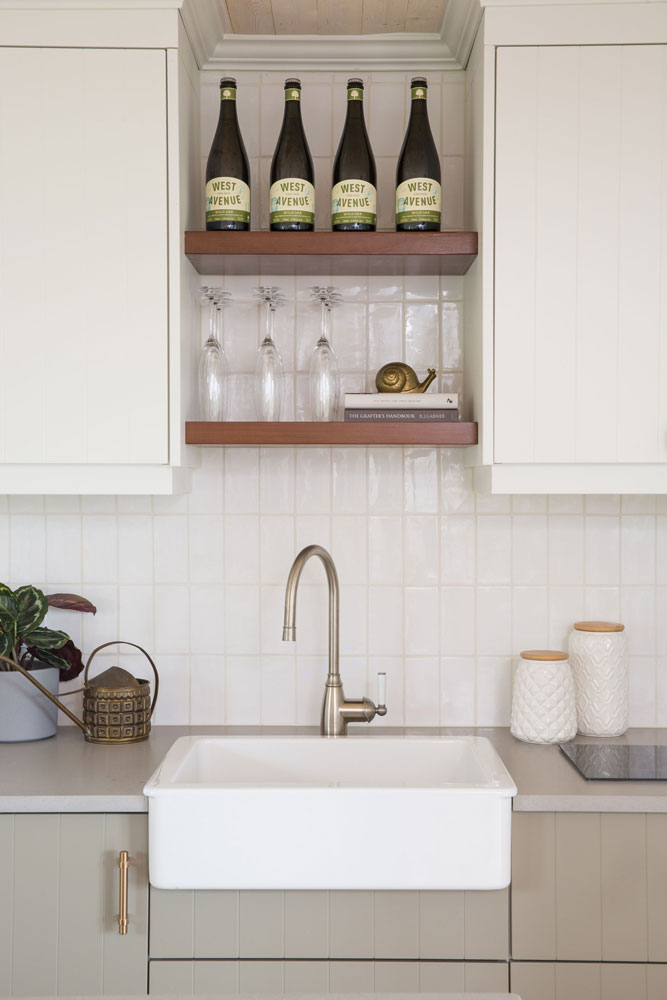 two wood shelves over apron sink and backsplash with vertical white subway tiles