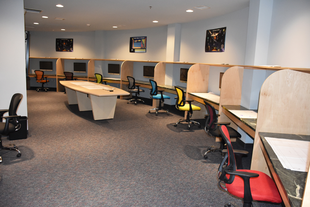 A spacious classroom in a condo bunker with multi computers