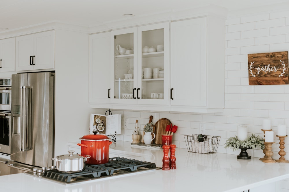clean white kitchen with white and glass cabinets