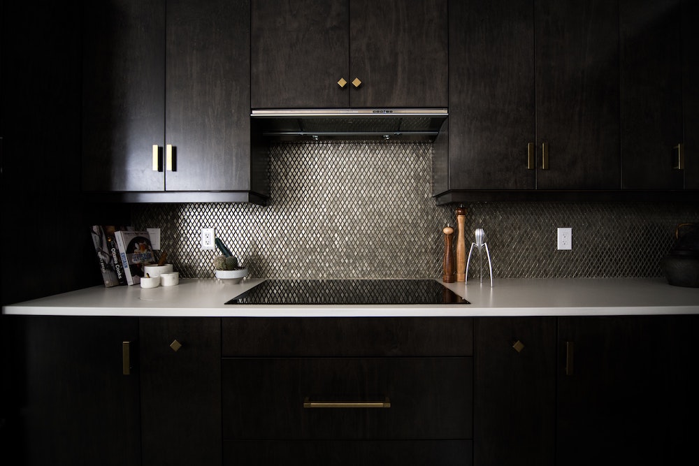 elegant dark kitchen cabinets with dark tiled backsplash