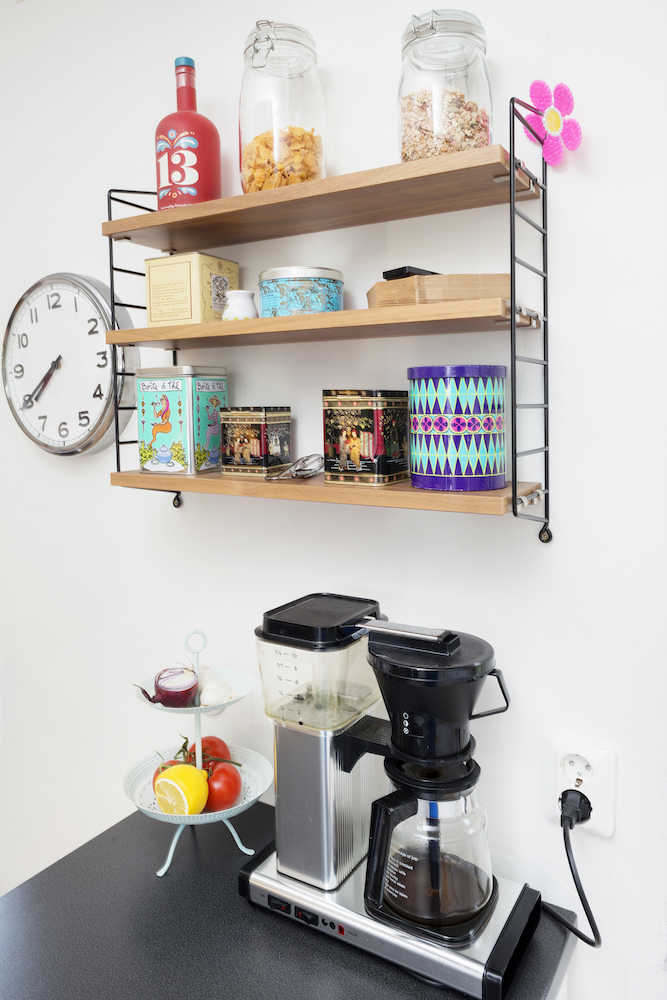 Coffee station with bright jars on wire-and-wood shelf