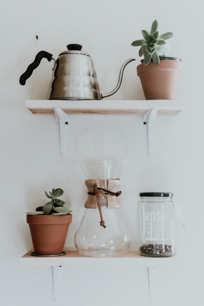 Kettle, pourover coffee and beans with succulents on shelf
