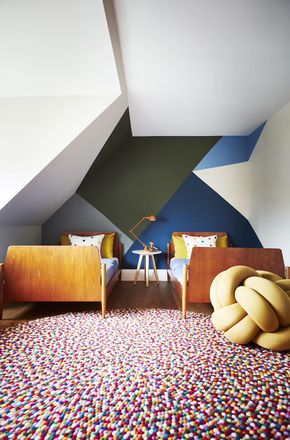 Angled kids' room with colour-blocked wall