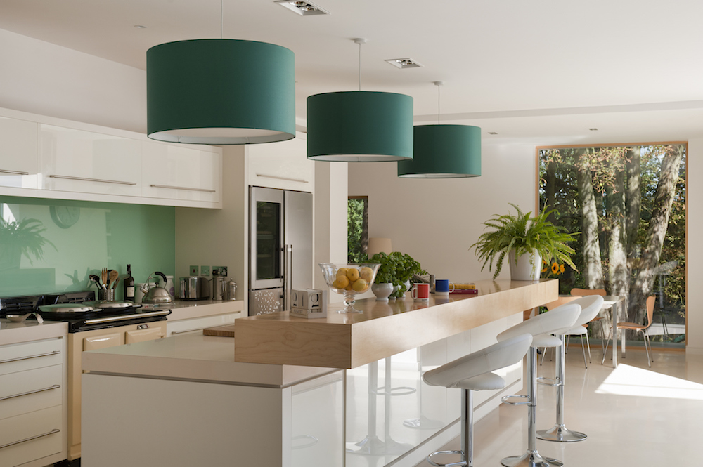 Contemporary kitchen with three green pendant lights